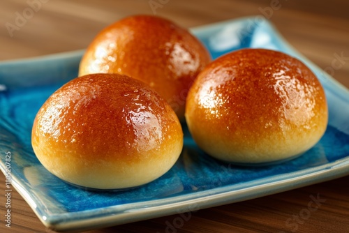 Freshly Baked Golden Brown Dinner Rolls Served on a Blue Plate