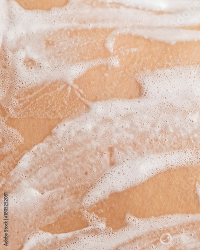 Macro photo of soapy foam texture on wet skin
