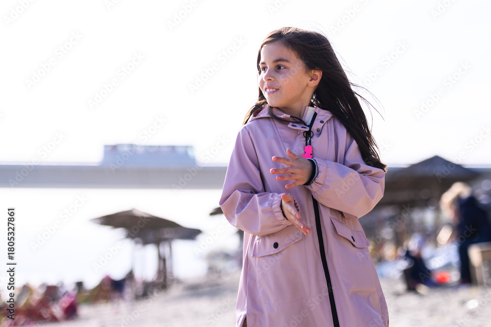 Fototapeta premium Happy young girl enjoying sunny day at beach