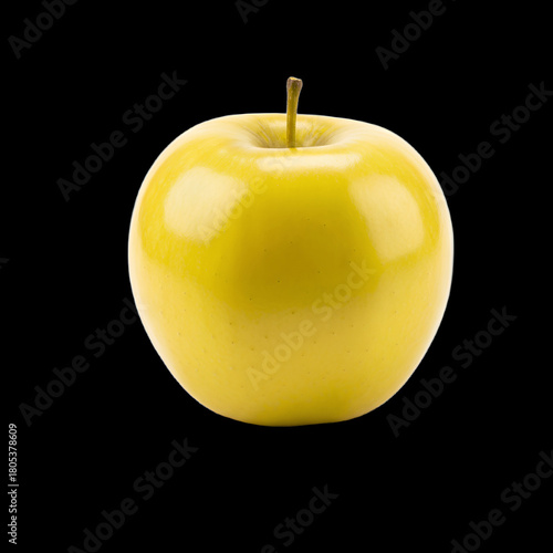 Single bright yellow apple with stem on a solid black background