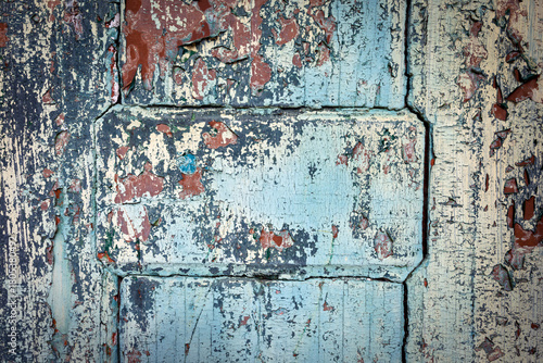 Φωτογραφία Close‑up of peeling turquoise paint on weathered wooden door panels, cracked and