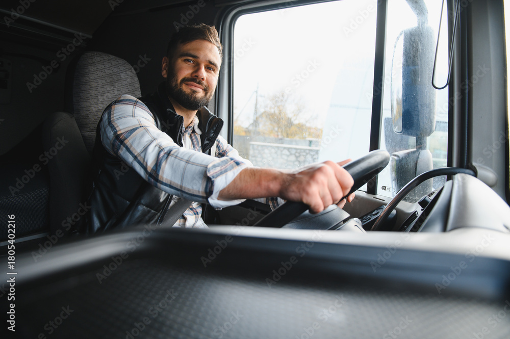 Obraz premium Truck driver smiling driving commercial vehicle