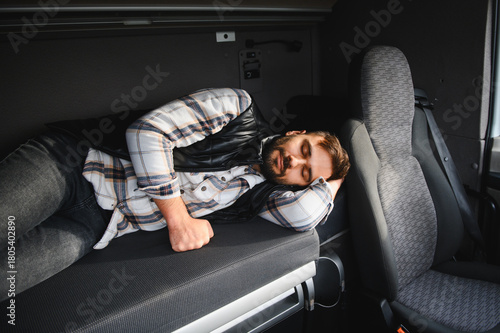 Truck driver sleeping resting inside sleeper cab