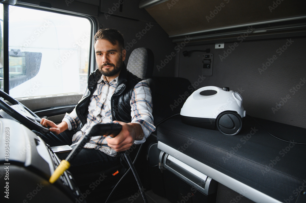 Obraz premium Trucker cleaning cab interior with steaming equipment