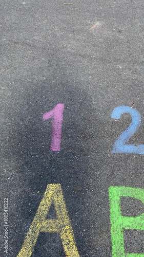 men’s shadows on a playground with the alphabet written on the asphalt. The scene symbolizes winer and victory or first place. Vertical video