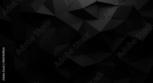 Abstract black 3D surface composed of polygonal shapes, creating varying levels of shadow and highlight across the texture