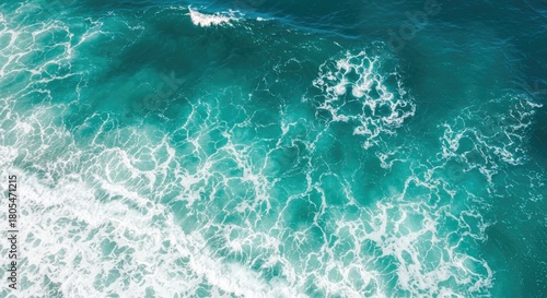 Overhead shot of churning ocean waves in varying shades of teal and turquoise, creating a textured and dynamic surface