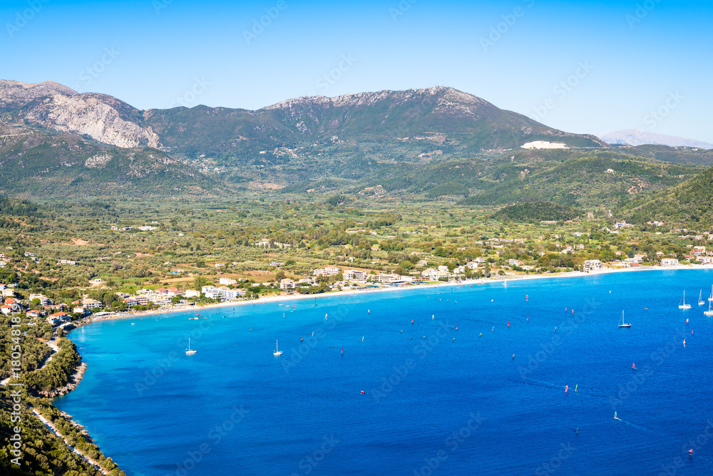Obraz premium View of sea bay with beach and mountains above Vassiliki port, Lefkada island, Greece