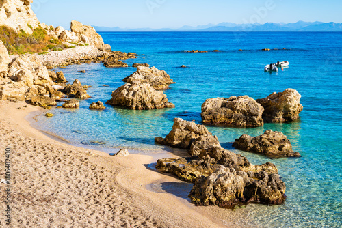 Fototapeta Naklejka Na Ścianę i Meble -  Rocks in crystal clear sea water on beach in Agios Nikitas village, Lefkada island, Greece