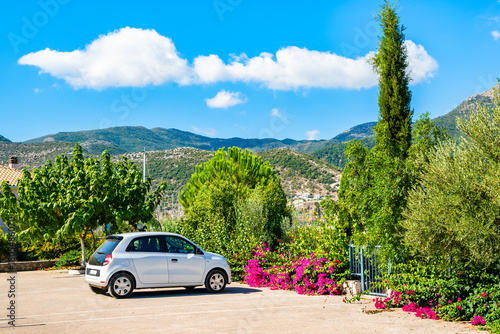 Canvas-taulu White car parking in Geni village with beautiful landscape in background, Lefkad