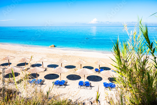 Umbrellas and sunbeds on beautiful sandy Avali beach, Lefkada island, Greece