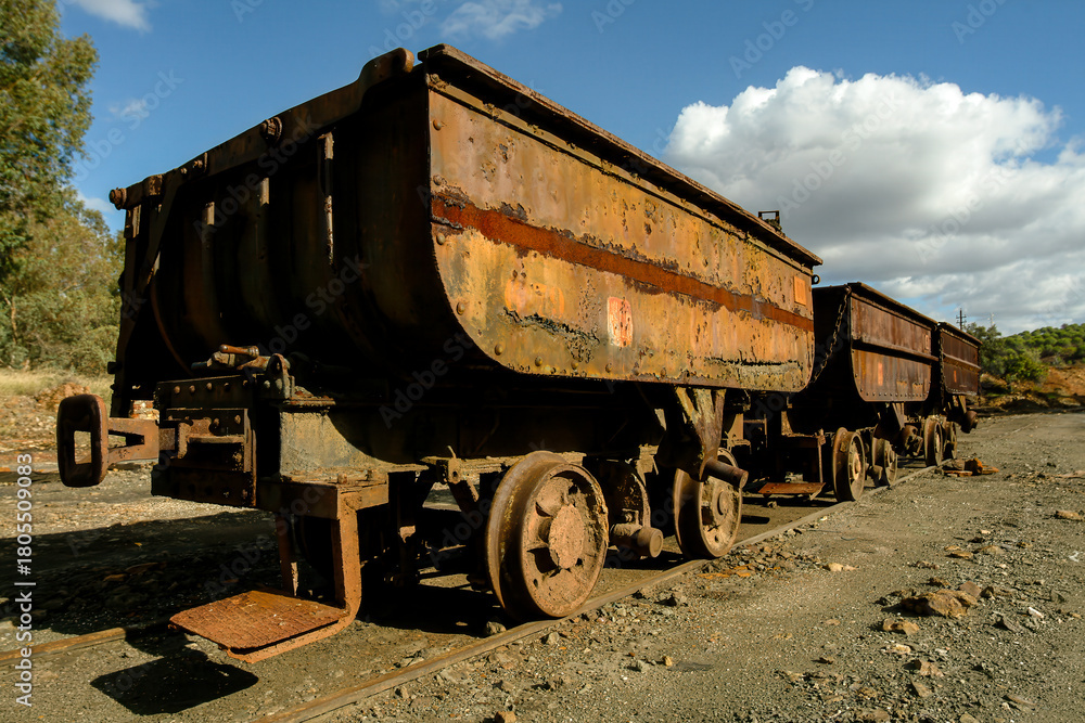 Naklejka premium Abandoned ore carts on rusted tracks at Rio Tinto Mine in Spain