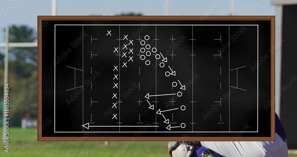 Fototapeta premium Showing framed chalkboard with Xs Os diagram on field, helmeted player with shoulder pads watching