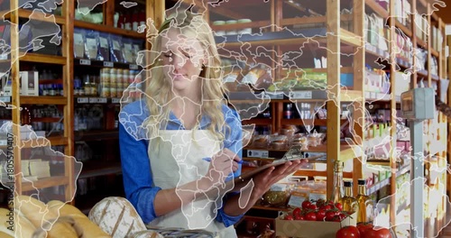 Grocery clerk writing stock notes, causing world map overlay moving across shelves showing origins
