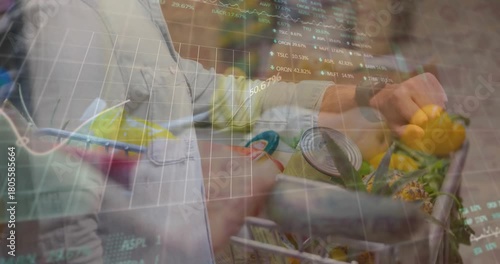 Two shoppers pushing cart in produce aisle, finance charts fading in over pepper, tracking spending