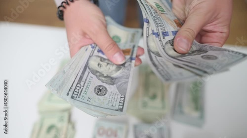 offering cash for transaction, close view of hands presenting assorted banknotes for exchange or gratuity, detailed shot of hands extending variety of bills for payment or tip purposes