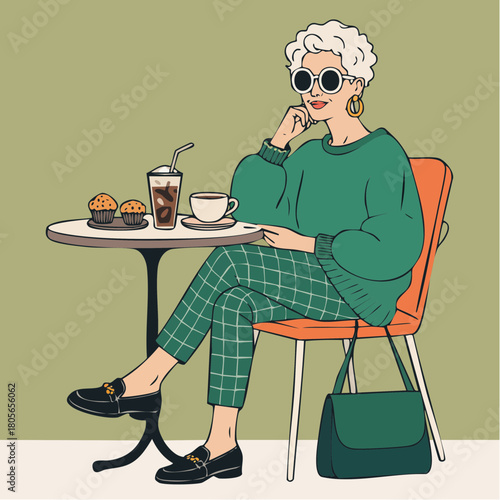 relaxed café patron in green sweater with pastries and iced coffee