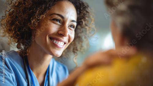 A caregiver smiles warmly while engaging with an elderly person, showcasing compassion and kindness in healthcare.
