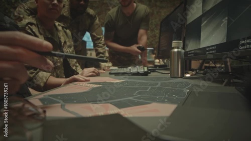 Military Team Strategizing Over a Satellite Map During Night Surveillance