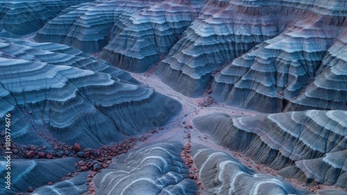 Surreal panoramic landscape of blue layered rock formations in the desert. Abstract aerial view of eroded bentonite hills with intricate patterns and natural textures