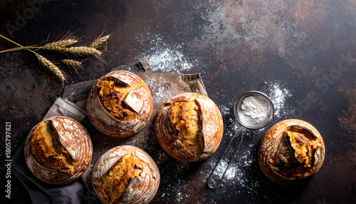 Artisan sourdough bread loaves on rustic dark table