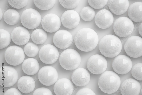 cluster of glossy white foam spheres of varying sizes arranged in a repetitive pattern creating a calm minimalist tactile texture