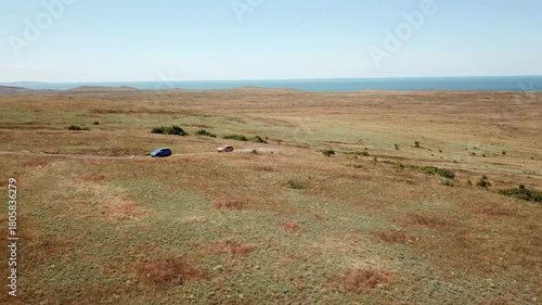 Aerial view. Cars go across the field. General's beaches, Crimea