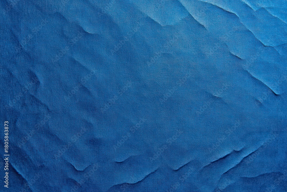 Fototapeta premium textured deep blue crumpled paper surface with soft folds torn edges subtle shadows and a calm serene mood