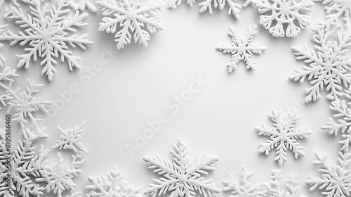 White winter themed background featuring scattered decorative snowflake shapes arranged in frame with soft shadows creating festive and elegant atmosphere for seasonal design