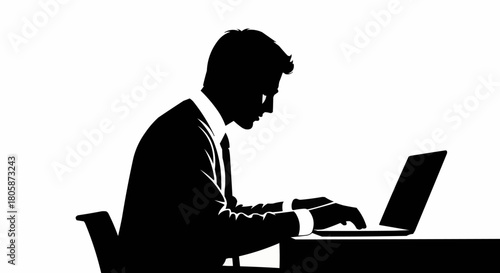 Side profile silhouette of a professional man using a laptop computer.