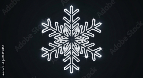 A luminous white snowflake glows against a stark, creating a striking contrast for winterthemed designs and festive holiday projects