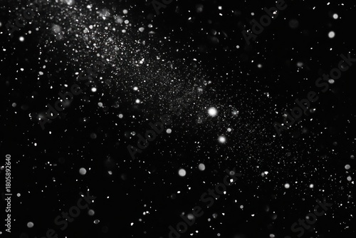 Ethereal white particles and glowing specks floating against a deep black background, creating a mysterious and serene starry atmosphere