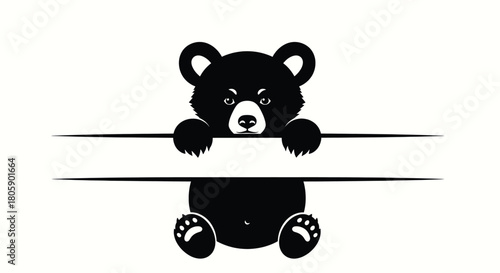 Adorable black bear cub peeking over a line, with blank space for text