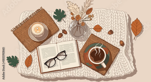 Cozy autumn scene with coffee book candle and fall leaves on a knitted blanket