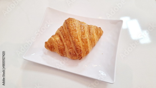 Fresh Golden Croissant Pastry on White Plate for Gourmet Bakery Promotion