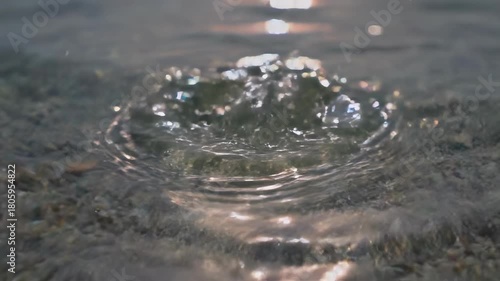 Macro shot of a clear water surface reflecting colorful sunlight creating beautiful, dancing ripple effects effect, abstract, reflection