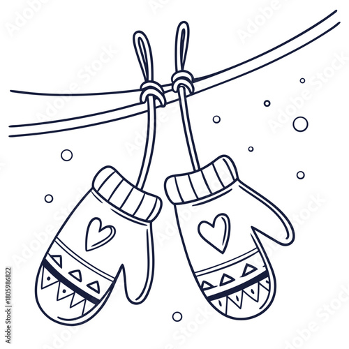 Pair of winter mittens hanging on a line