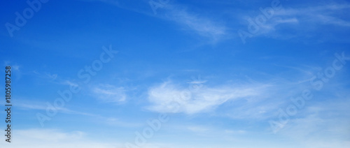 The sky is bright blue with cotton-like clouds floating above it.