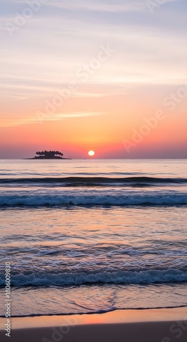 Island in the ocean during sunset with gentle waves on a sandy beach sea