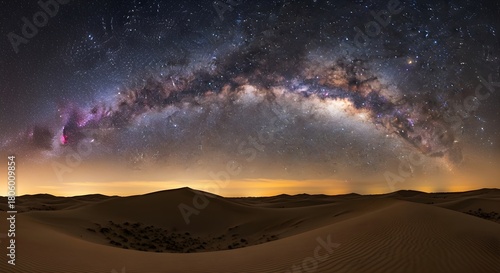 Fototapeta Naklejka Na Ścianę i Meble -  The Milky Way arches majestically over vast desert sand dunes under a starry night sky