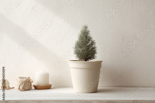 small christmas tree in clay pot decorated with single ornament creates enchanting centerpiece