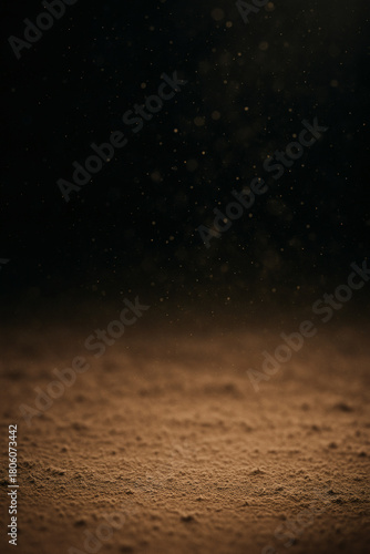 A dramatic tableau unfolds: dust motes dance in light against a dark backdrop, illuminating the ground below, a dance of light and shadow.