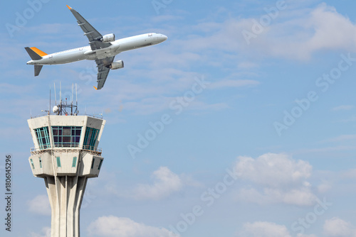 Air traffic control tower and passenger aircraft. Flights cancelled in war and conflict conditions. Air transportation idea concept. Plane crashes. Copy space, blank, empty.	