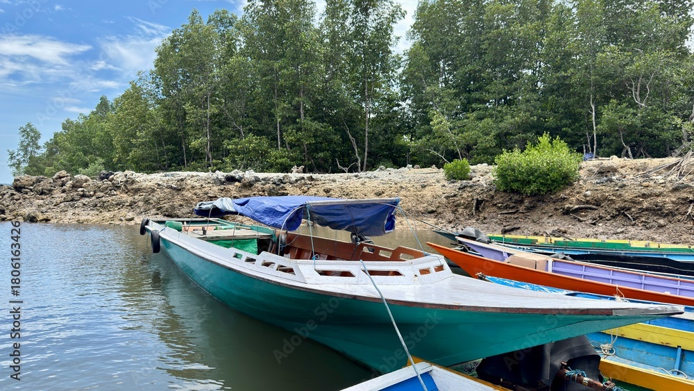 custom made wallpaper toronto digitalColorful boats are anchored on the banks of a calm river estuary lined with lush green trees.
