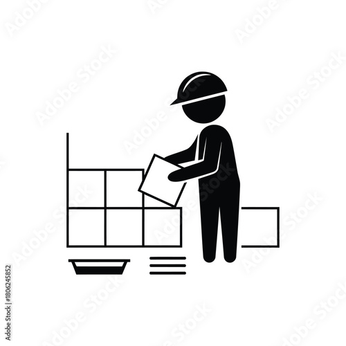 Construction worker placing tiles on a wall