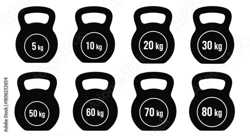 A collection of black kettlebells with varying weight markings displayed
