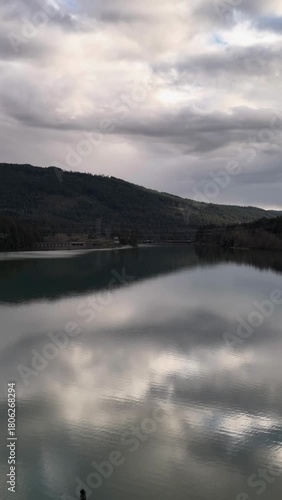 Serene Lake Reflections of Cloudy Sky and Majestic Mountains in British Columbia, Canada
