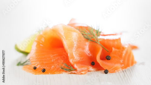 Fototapeta Naklejka Na Ścianę i Meble -  fresh smoked salmon slice with black pepper, dill and lemon