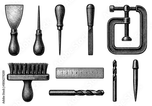 Vintage engraved hand tools collection with brushes, rulers, and drills for workshop decor