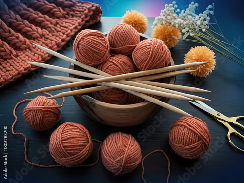 Knitting supplies with yarn, needles, and scissors on dark desk